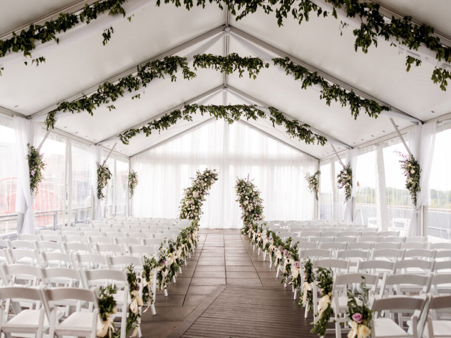 Ceremony Setup on the rooftop with greenery installs and purple roses {{brizy_dc_image_alt imageSrc=