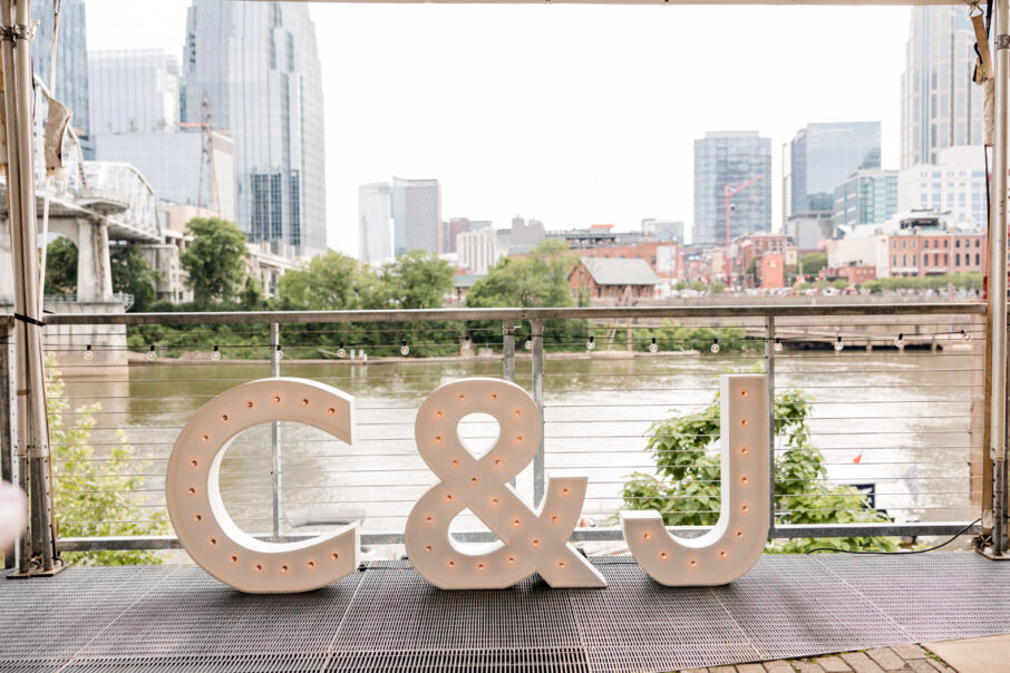 C and J Marquee Letters on Riverside Patio during the Day {{brizy_dc_image_alt imageSrc=