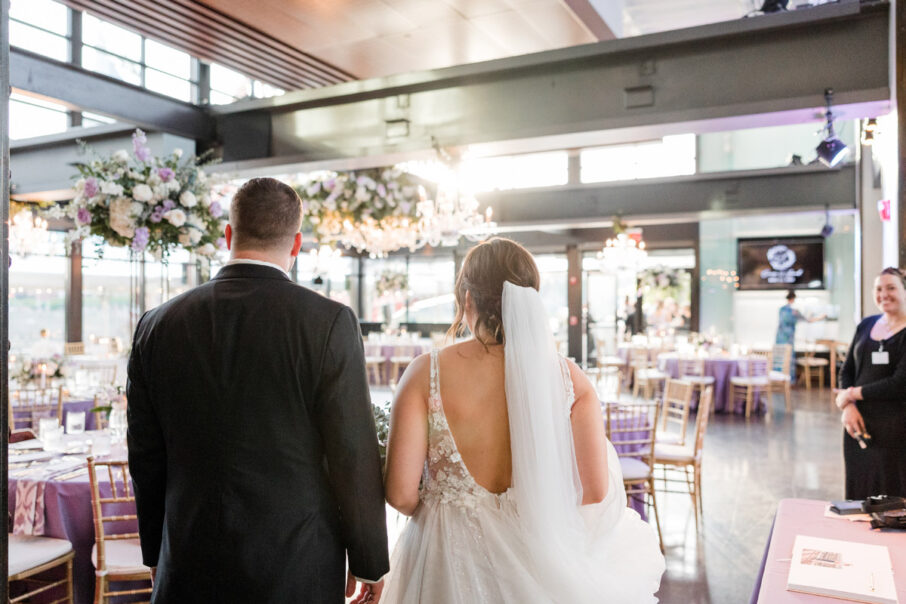 Bride and groom see their wedding reception set up for the first time after the ceremony {{brizy_dc_image_alt imageSrc=