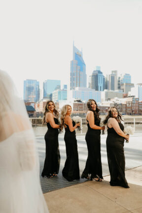 Haley's First Look with bridesmaids on Riverfront Patio {{brizy_dc_image_alt imageSrc=