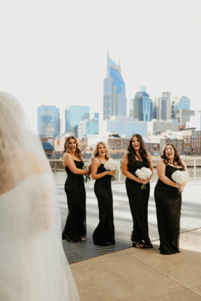 Haley's First Look with bridesmaids on Riverfront Patio {{brizy_dc_image_alt imageSrc=