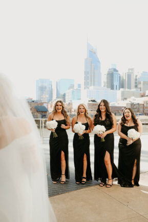 Haley's First Look with bridesmaids on Riverfront Patio {{brizy_dc_image_alt imageSrc=