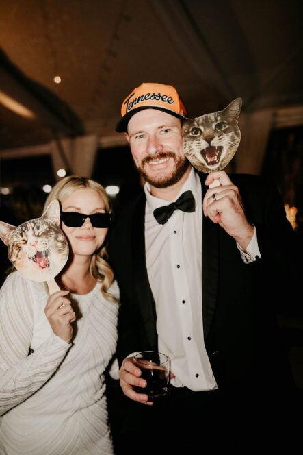 Haley and Andrew with their cat signs during reception {{brizy_dc_image_alt imageSrc=