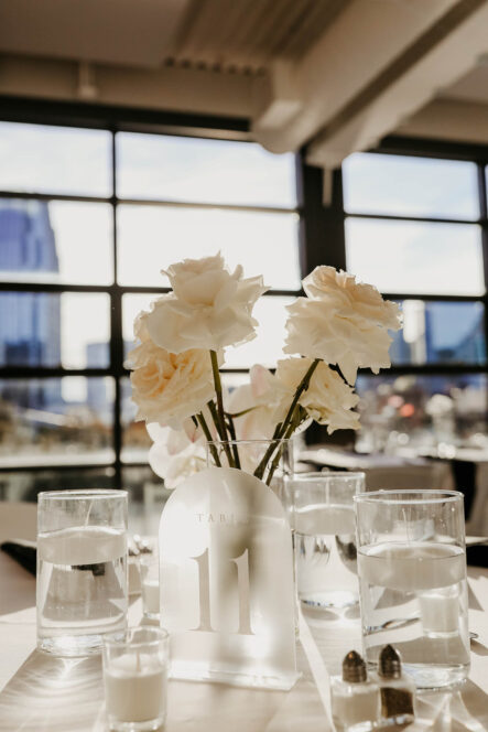 Classic White Rose Centerpiece with White Acrylic Table Number {{brizy_dc_image_alt imageSrc=