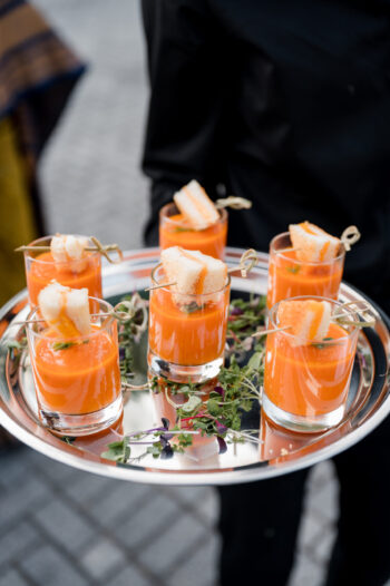 Mini tomato soup shooters with small grilled cheeses on silver tray {{brizy_dc_image_alt imageSrc=